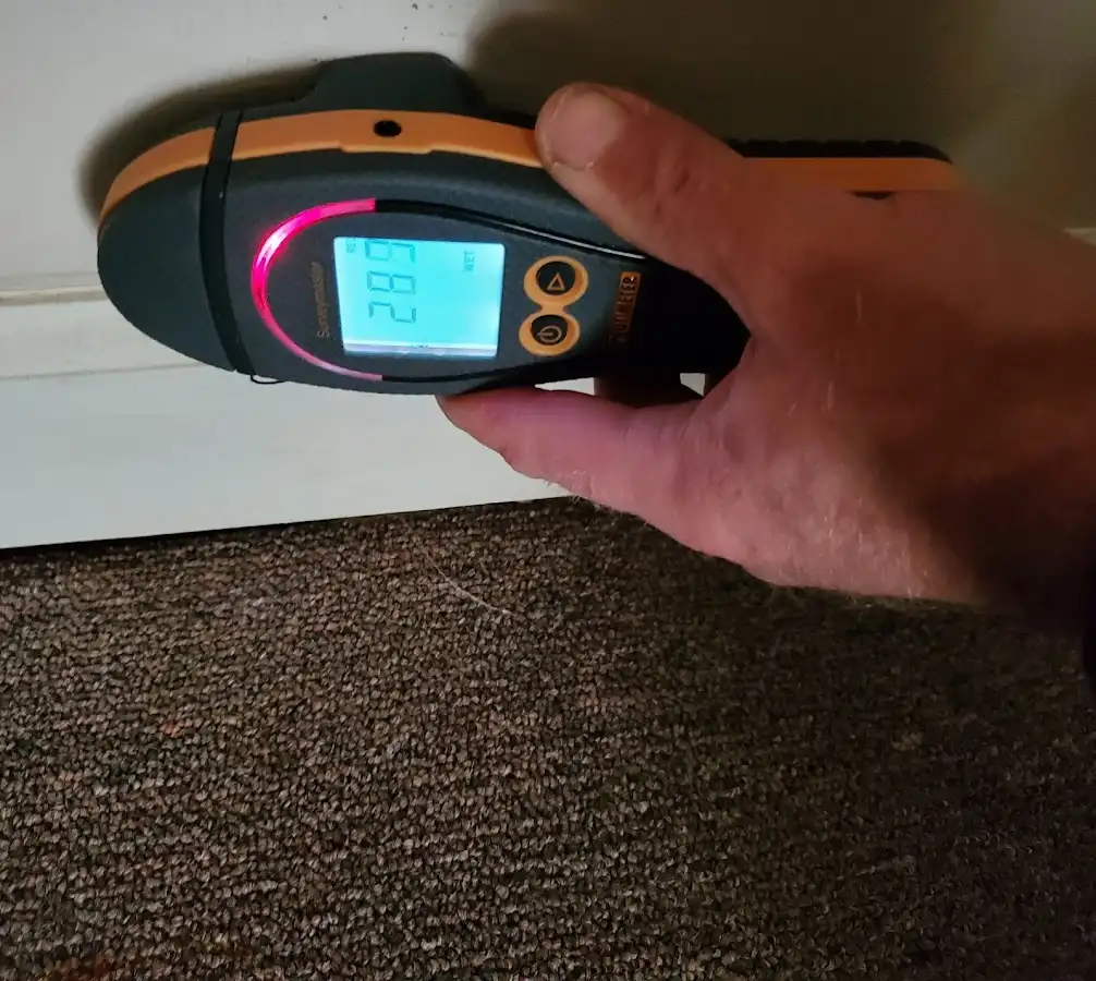 Moisture detection at baseboard during Storm Damage Restoration in West Dundee